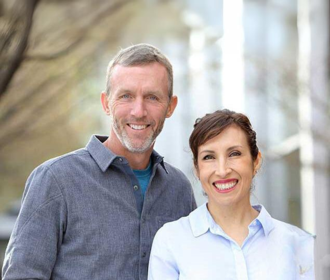 Smiling man and woman standing together outdoors